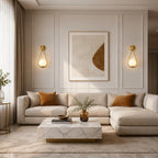 Gold glass loop arm Nordic wall sconces flanking abstract artwork above large sectional sofa in classic panelled living room