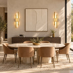 Gold double bar modern rechargeable LED wall light mounted in a dining room, adding warm ambient accent lighting throughout.