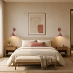 Pair of pink macaron cone retro wall sconces beside a bed in a warm Scandinavian-inspired bedroom