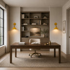 Yellow macaron cone retro wall sconces flanking a bookshelf above a wooden desk in a stylish home study