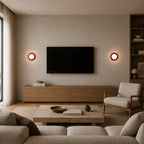 Pair of Mini Glass Orb Nordic Wall Lights in red flanking a TV wall in a Nordic living room