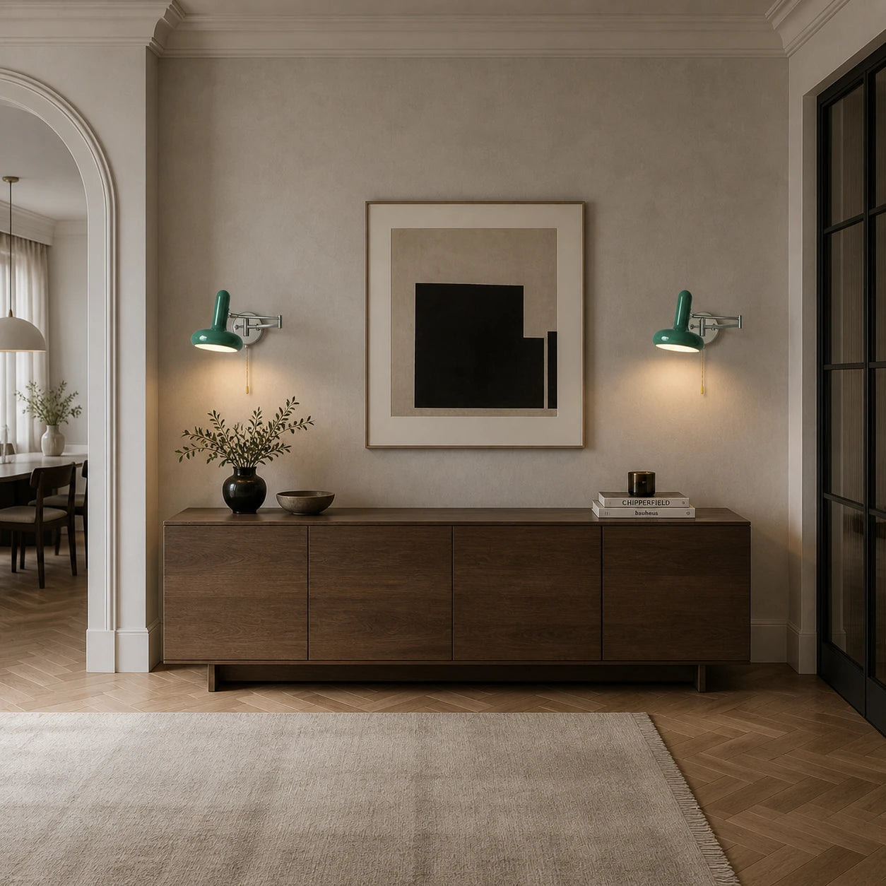 Green swing arm retro wall lights flanking a sideboard and abstract artwork in a bright entrance hallway
