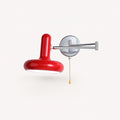 Pull cord swing arm retro wall light in red with pull cord — bold retro accent for feature bedroom walls.