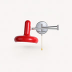Pull cord swing arm retro wall light in red with pull cord — bold retro accent for feature bedroom walls.