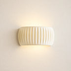 Ribbed resin Nordic wall light in cream — clean product view of the ribbed cylindrical shade in neutral cream finish.