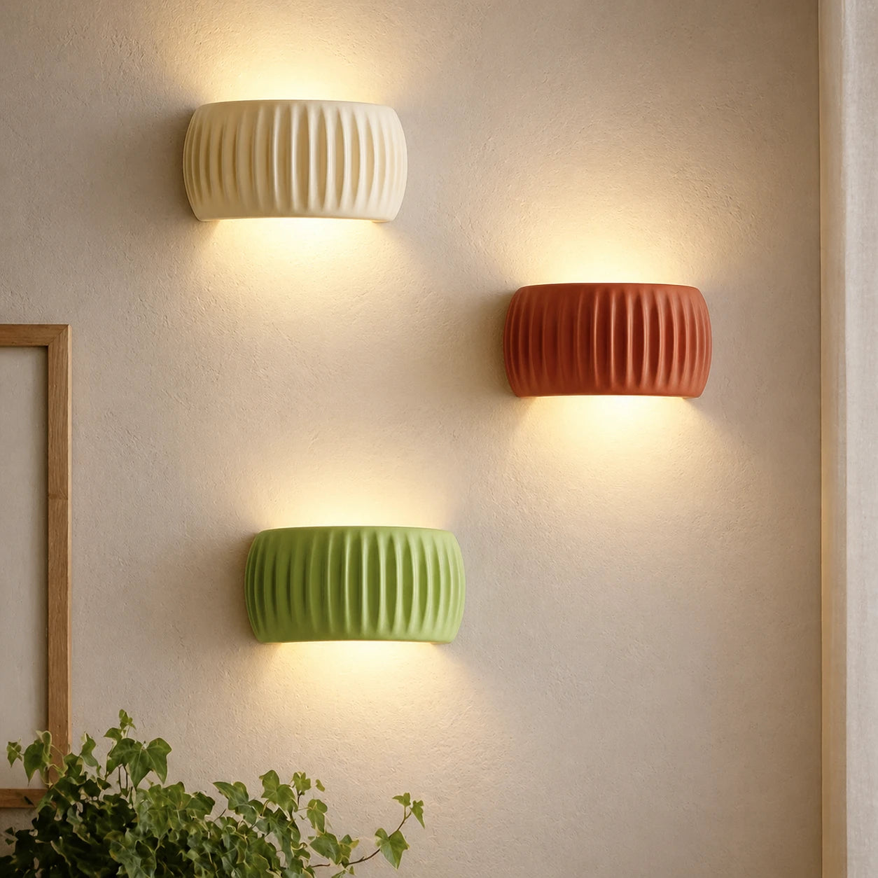 Ribbed resin Nordic wall light in sage green — ribbed cylindrical shade on a slim wall bracket for a natural Nordic bedroom.