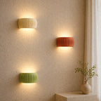 Ribbed resin Nordic wall light in terracotta — warm earthy tone for boho and natural Scandinavian interiors.