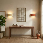 Ribbed resin Nordic wall light in a boho-inspired bedroom, nestled among natural textures and warm earthy tones.