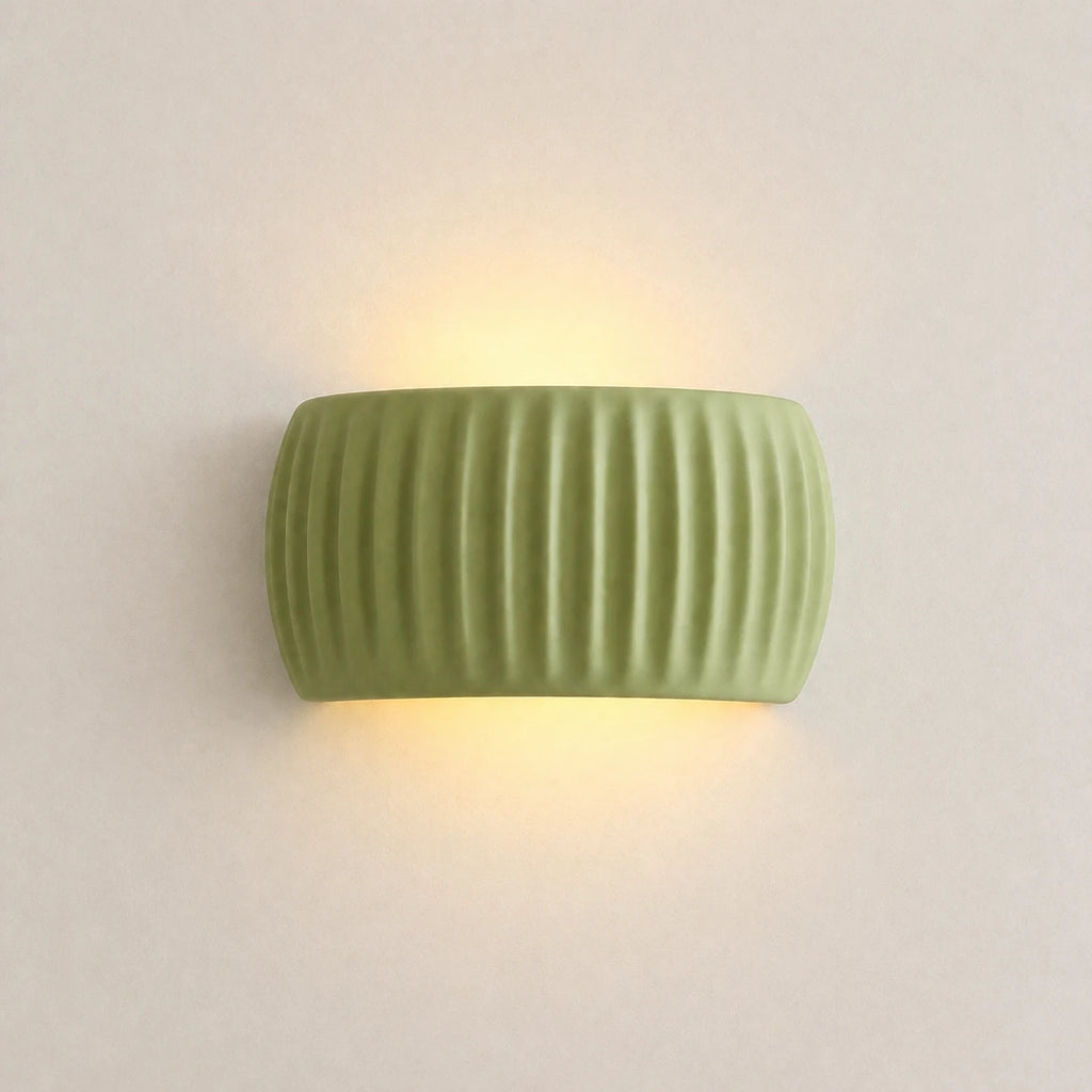 Ribbed resin Nordic wall light in sage green — clean product view of the ribbed cylindrical shade in muted green finish.