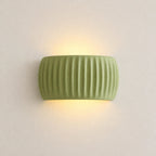 Ribbed resin Nordic wall light in sage green — clean product view of the ribbed cylindrical shade in muted green finish.