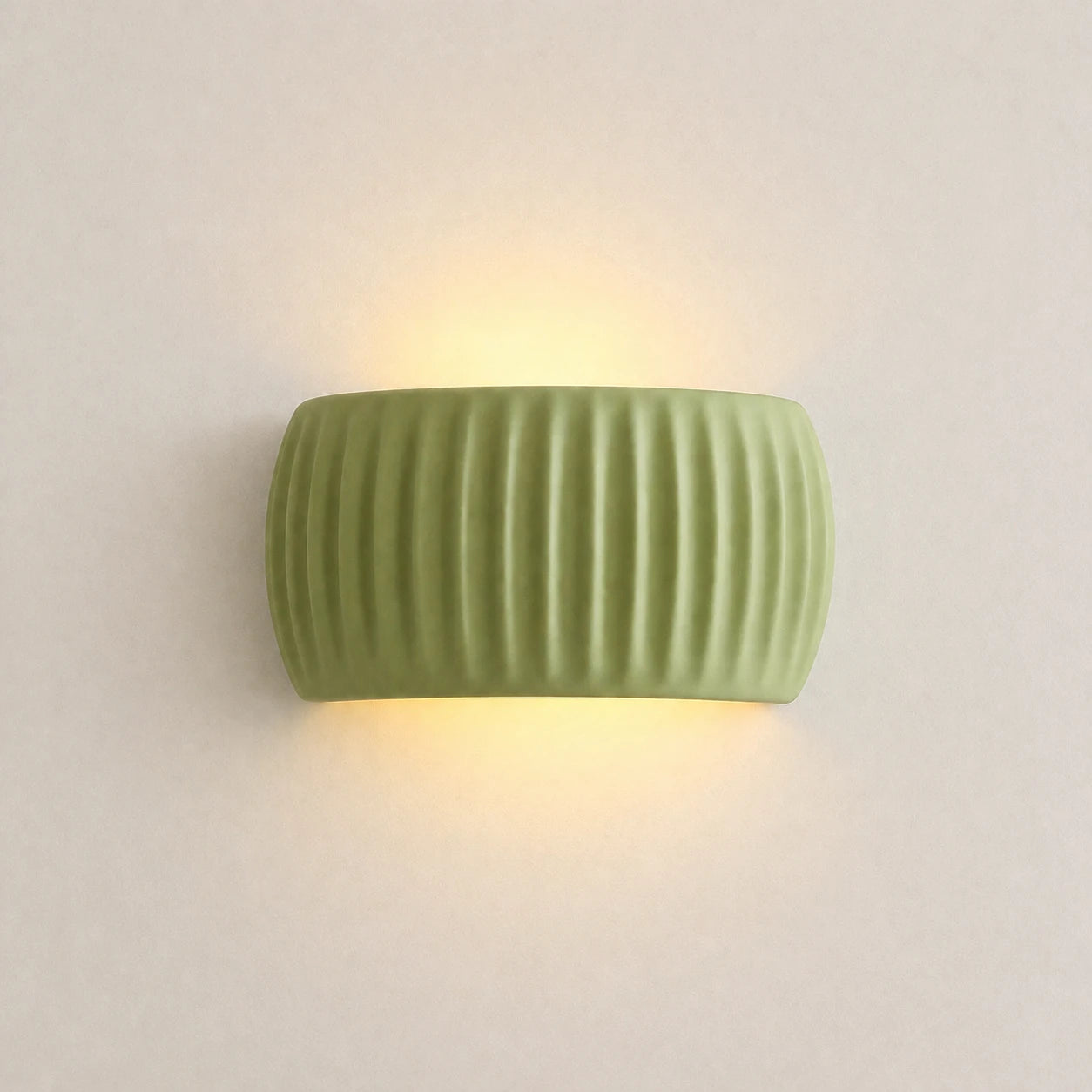 Ribbed resin Nordic wall light in sage green — clean product view of the ribbed cylindrical shade in muted green finish.