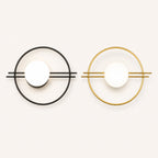 Ring frame globe LED modern wall sconce shown in black and gold finish options with white opal globe shade