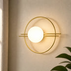 Ring frame globe LED modern wall sconce with circular gold ring frame and opal white globe second angle hero shot