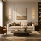 Copper rotatable LED wall lights flanking a sofa and artwork in a warm contemporary living room with armchair