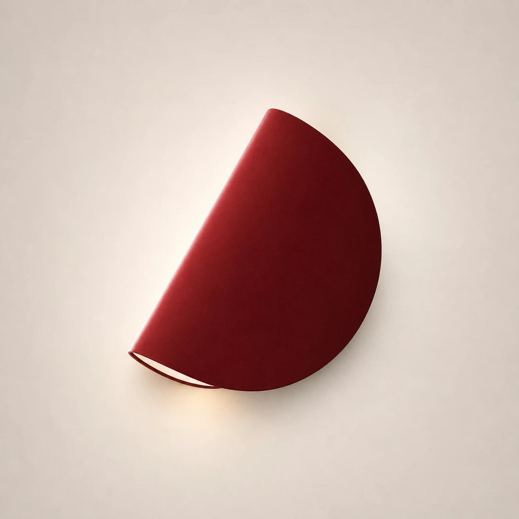 Rotating half-disc LED modern wall light in red — a vibrant colour accent for contemporary and eclectic bedroom walls.