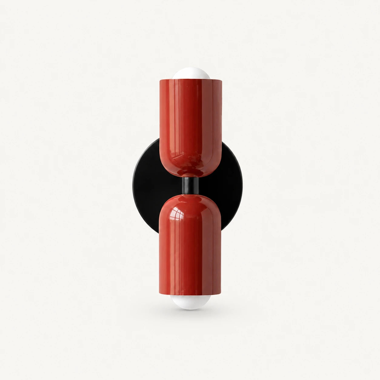 Two-tone Nordic indoor wall light — red cylindrical shades on a black circular backplate for a bold contrast statement wall.
