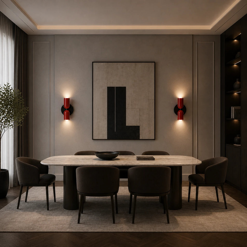 Pair of red two-tone Nordic up and down wall lights flanking bold abstract artwork in a moody dining room.