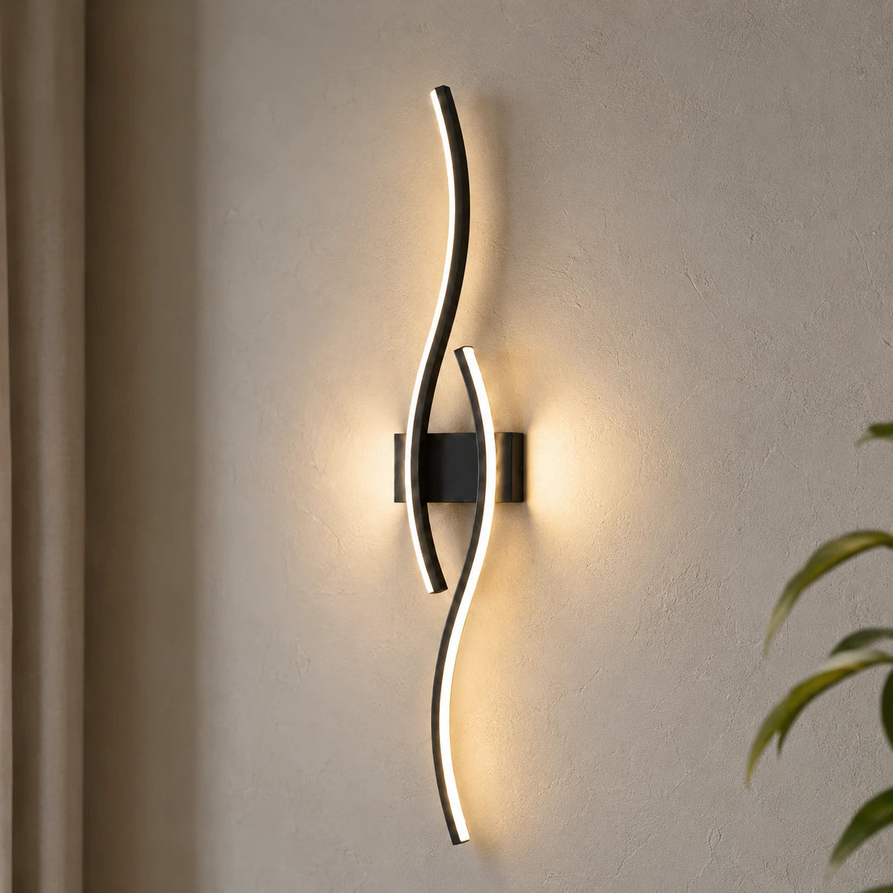 Wave LED modern wall light close up — the curved LED panel lit brightly against a white wall.