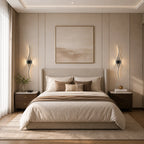 Pair of black wave LED wall lights either side of a bed in a calm neutral bedroom with nightstands