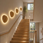 Wooden backlit LED Japandi wall light beside a sofa on a neutral wall, warming a minimal Japandi living room corner.